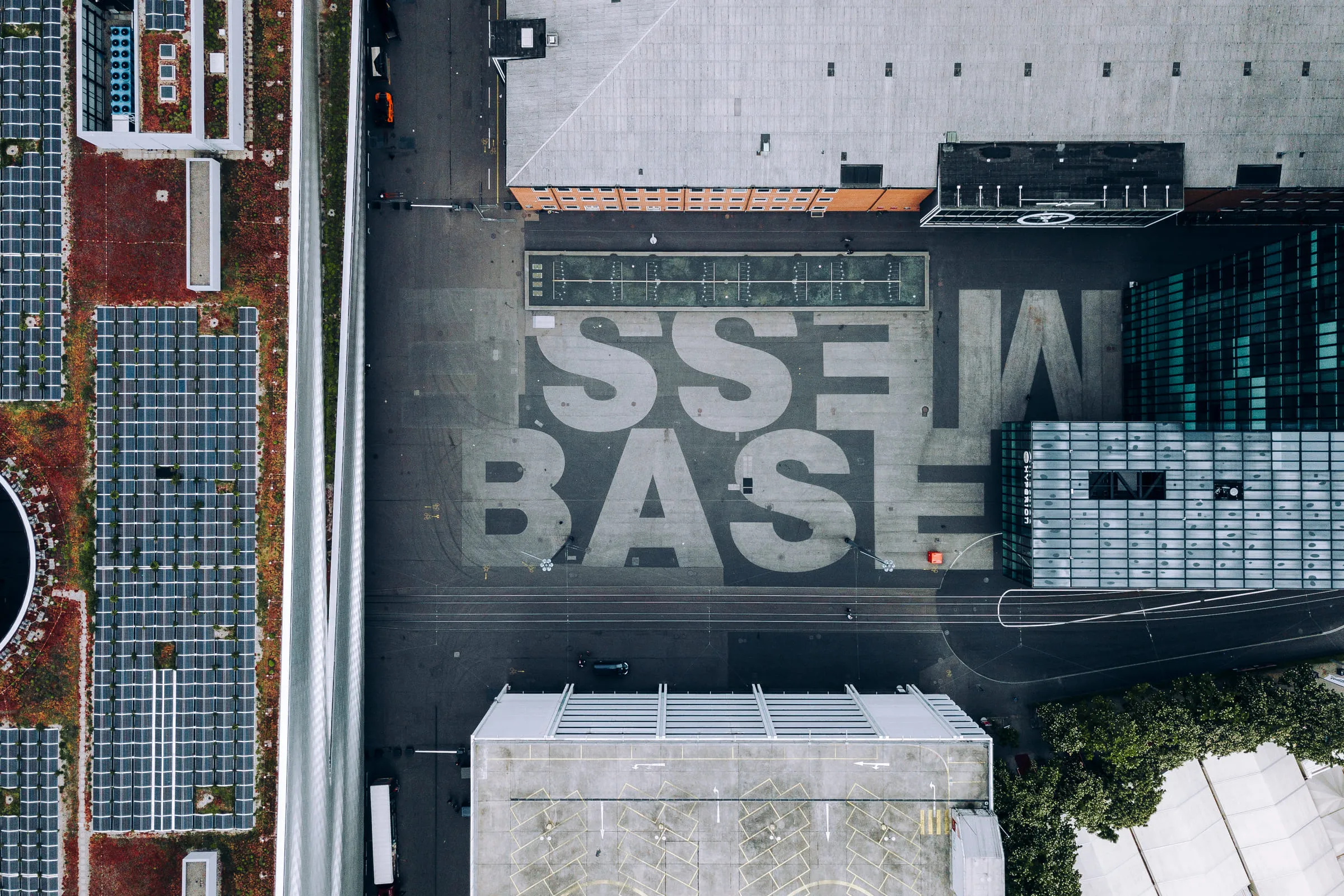 Messe Basel from the air, its name painted in large letters across the forecourt.